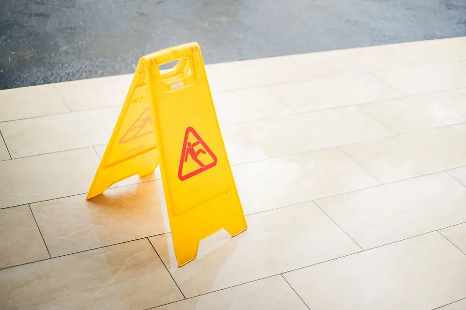 Wet floor sign on clean tile floor during commercial floor cleaning in Bridgeport, CT