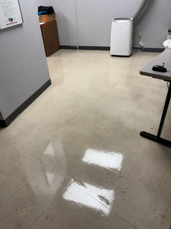 Glossy vinyl tile floor in a small commercial office room