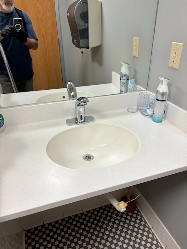 Clean commercial restroom sink and countertop, part of janitorial service