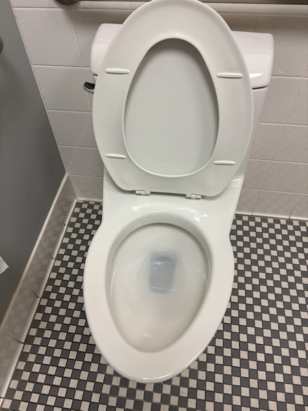 Clean commercial restroom toilet with the lid open