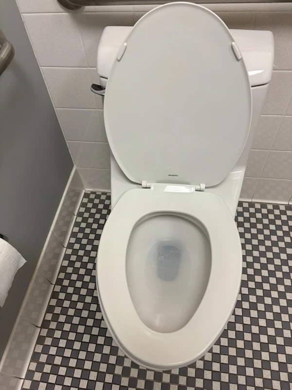 Clean commercial restroom toilet and tile floor, part of commercial cleaning