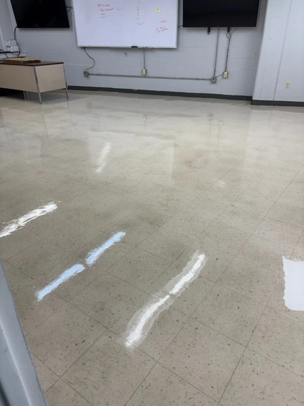 Freshly finished vinyl tile floor in a commercial training room