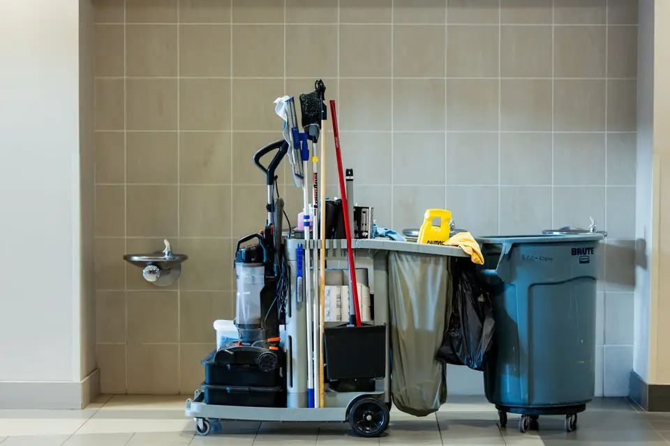 Janitorial cleaning cart with mop and supplies in a commercial hallway in Bridgeport, CT
